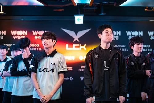 LCK players standing before a branded league backdrop LCK players standing before a branded league backdrop