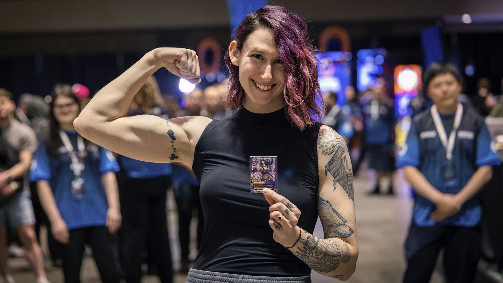 Riftbound Best-Of reward Riftbound player displaying a collectible card at a large organized play tournament