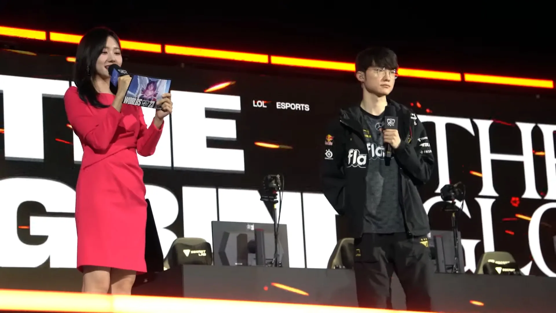 Faker speaking with a microphone beside another esports player Faker speaking with a microphone beside another esports player