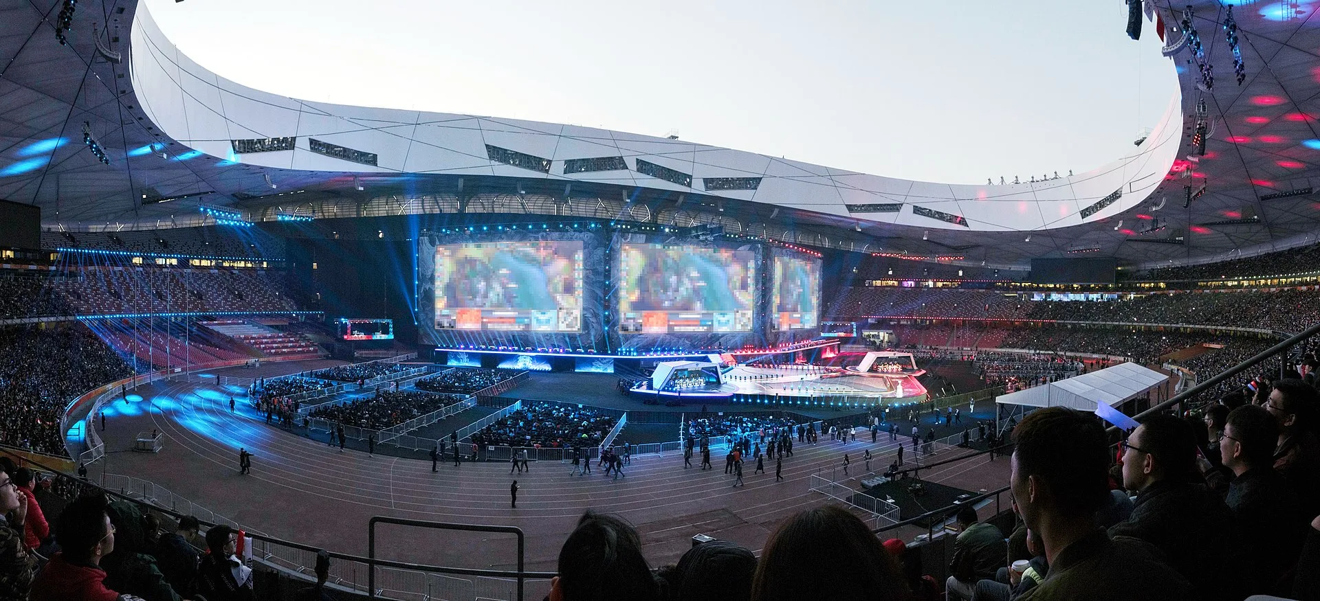 Worlds finals arena with massive dragon stage projection and crowd Worlds finals arena with massive dragon stage projection and crowd