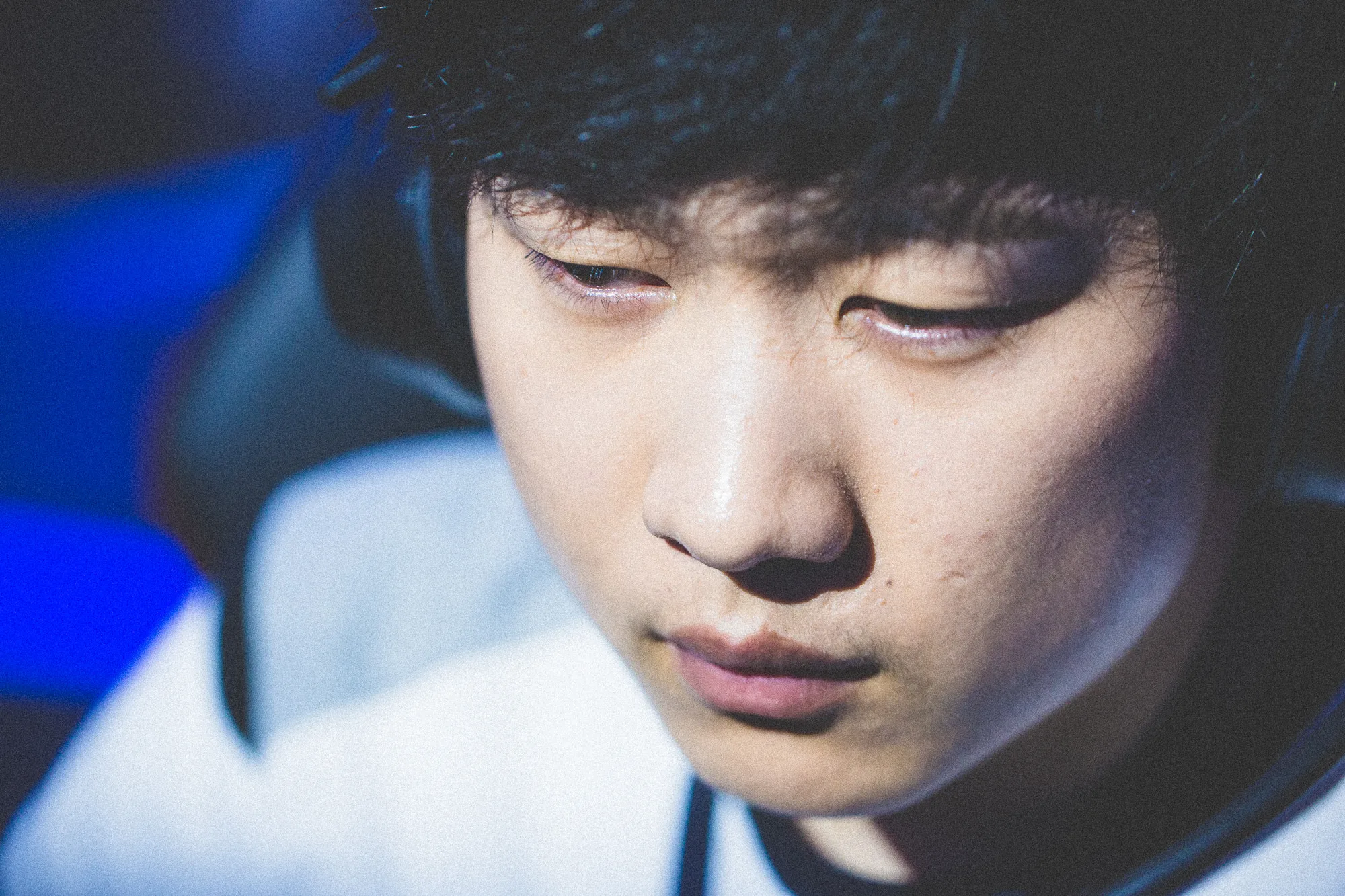 Professional LPL player wearing a headset during competition Professional LPL player wearing a headset during competition