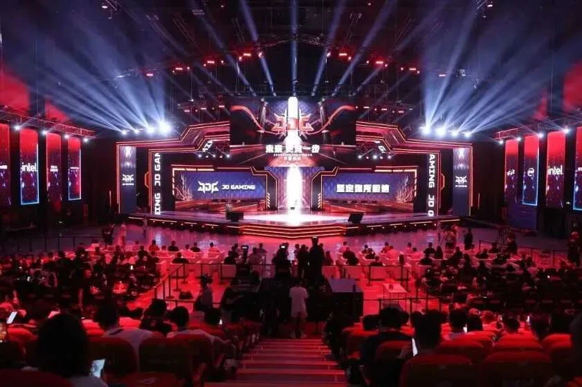 Demacia Cup 2026 playoff venue Wide view of the Beijing Smart E-Sports Center stage with JD Gaming branding, lighting and audience seating