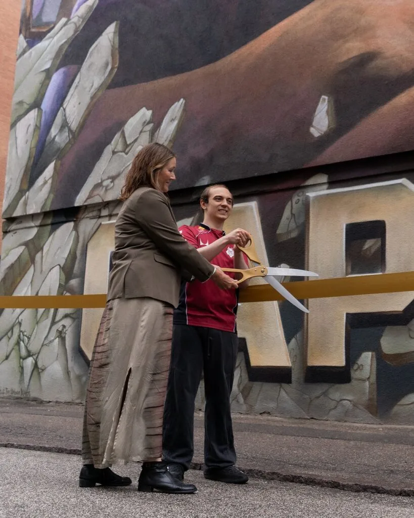 Caps cutting the ribbon for his mural.