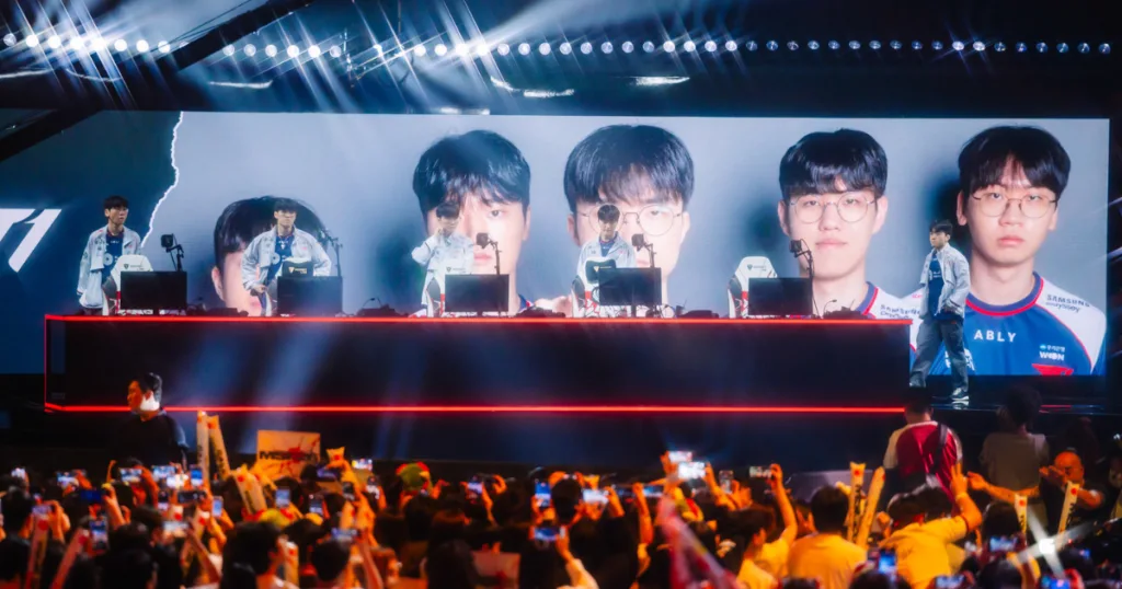 T1 on stage at MSI standing behind their setups. T1 on stage at MSI standing behind their setups.